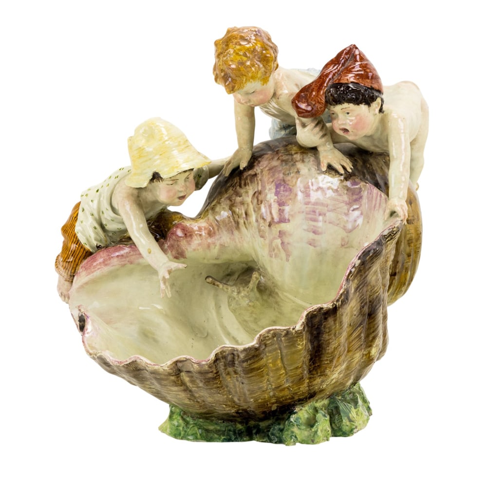 A Continental majolica group: A Continental majolica group, late 19th century, modeled as three children playing with a snail inside a large shell, unmarked, 14"h x 13.5"w x 16"d