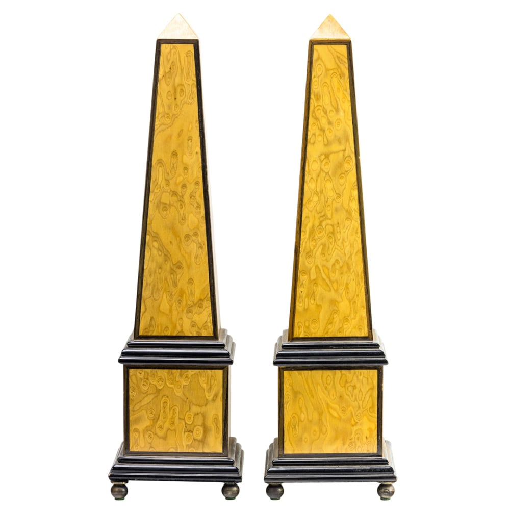 A pair of Neoclassical style partially ebonized satin wood obelisks: A pair of Neoclassical style partially ebonized satin wood obelisks, each raised on brass ball feet, 18.5"h x 5"sq (base)