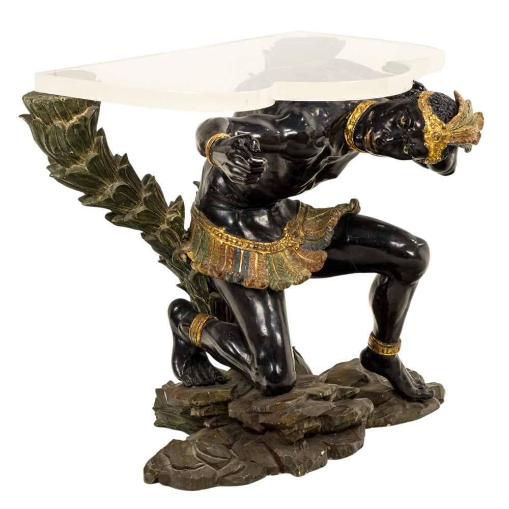 A fine pair of Venetian carved and polychrome blackamoor pedestal bases: A fine pair of Venetian carved and polychrome blackamoor pedestal bases, second half 19th century, each partially nude figure depicted crouching, adorned with a feather headdress and waist cover, with