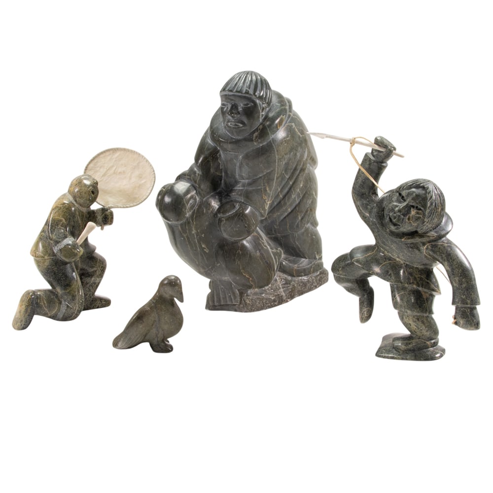 Four Inuit stone articles: Four Inuit stone articles, comprising a Josie Nulukie (b. 1941) figure of a hunter and seal, incised indistinctly to the underside with disc number 'E9-1660', 14"h; a figure of a hunter holding a harp