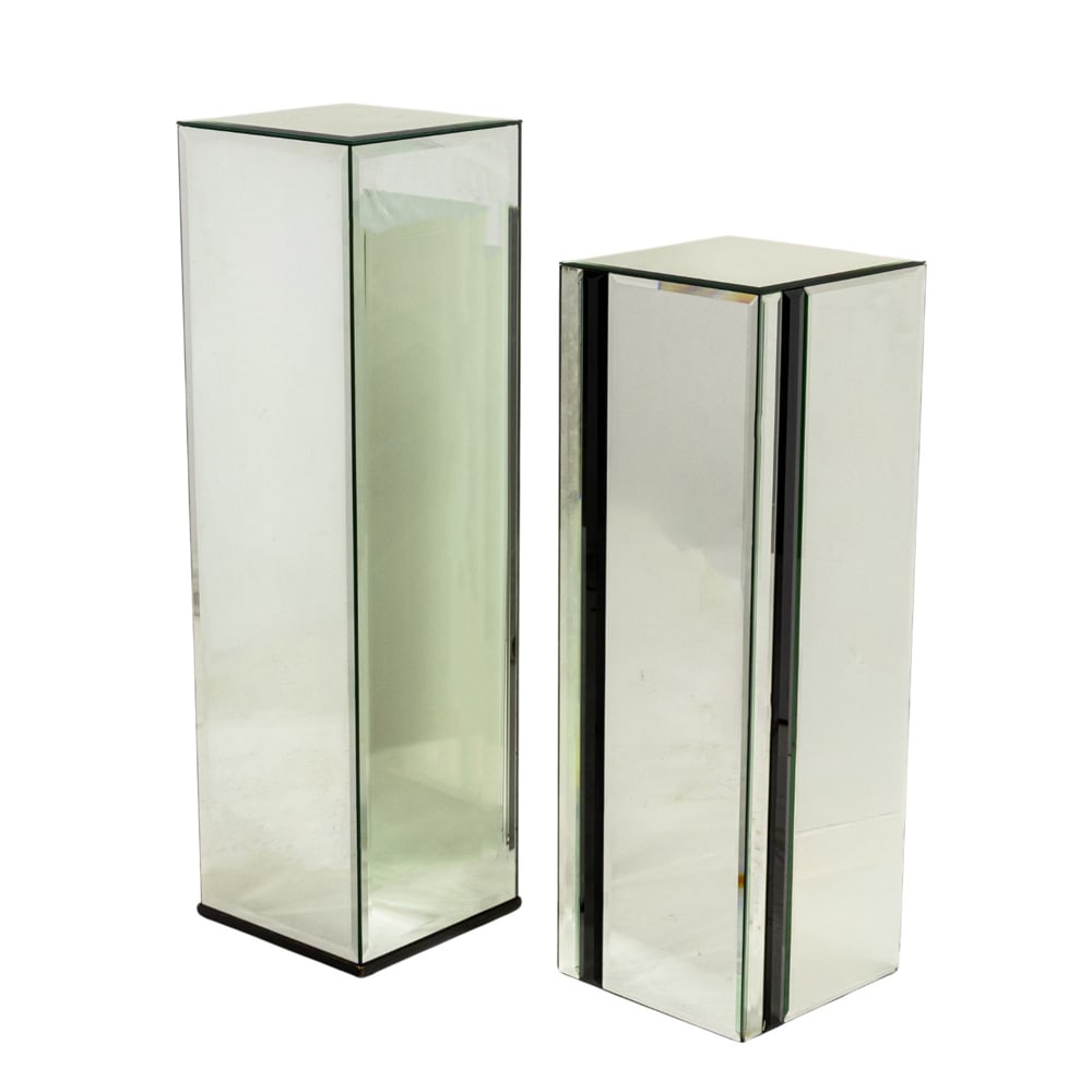 A group of two bevel mirrored pedestals: A group of two bevel mirrored pedestals, the taller 41"h x 12"sq, one with black glass pane inserts, 36"h x 12"sq