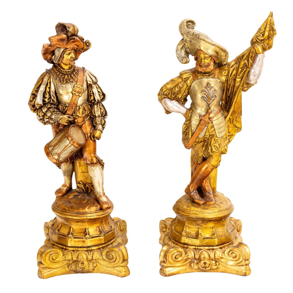 A pair of Renaissance style silvered and gilt plaster figures of cavaliers: A pair of Renaissance style silvered and gilt plaster figures of cavaliers, each raised on scrolled stand, between 39"h x 14"sq and 38"h x 14"sq. Provenance: A private collection, Hillsborough, CA