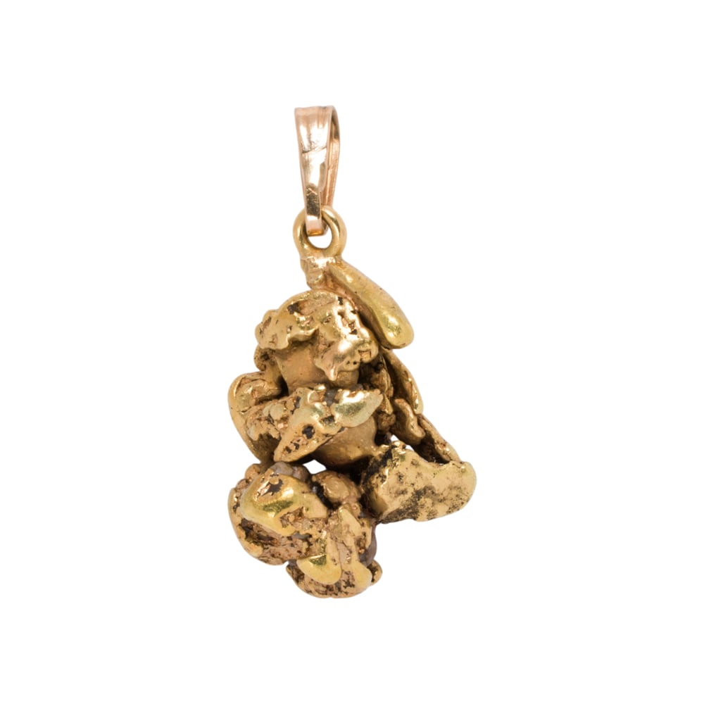 A gold nugget pendant: A gold nugget pendant Featuring a freeform 24k gold nugget on 14k gold bail; length: 1 in; 6.75 grams