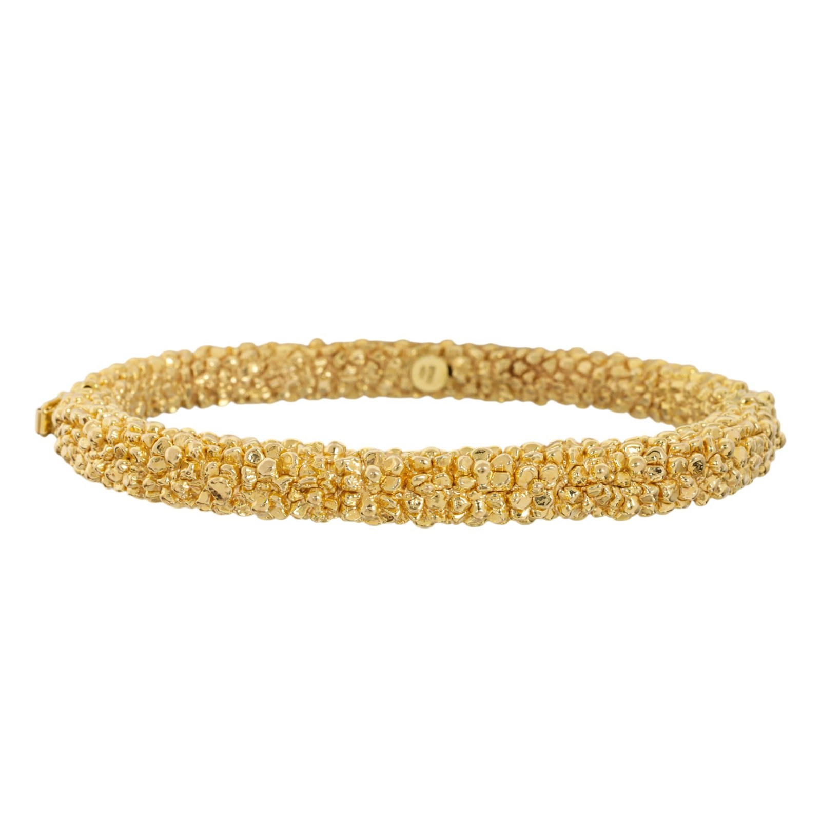 An 18k gold bracelet: An 18k gold bracelet Of textured, hollow-form design featuring floral accents; interior width: 2 3/8 in; 8.55 grams