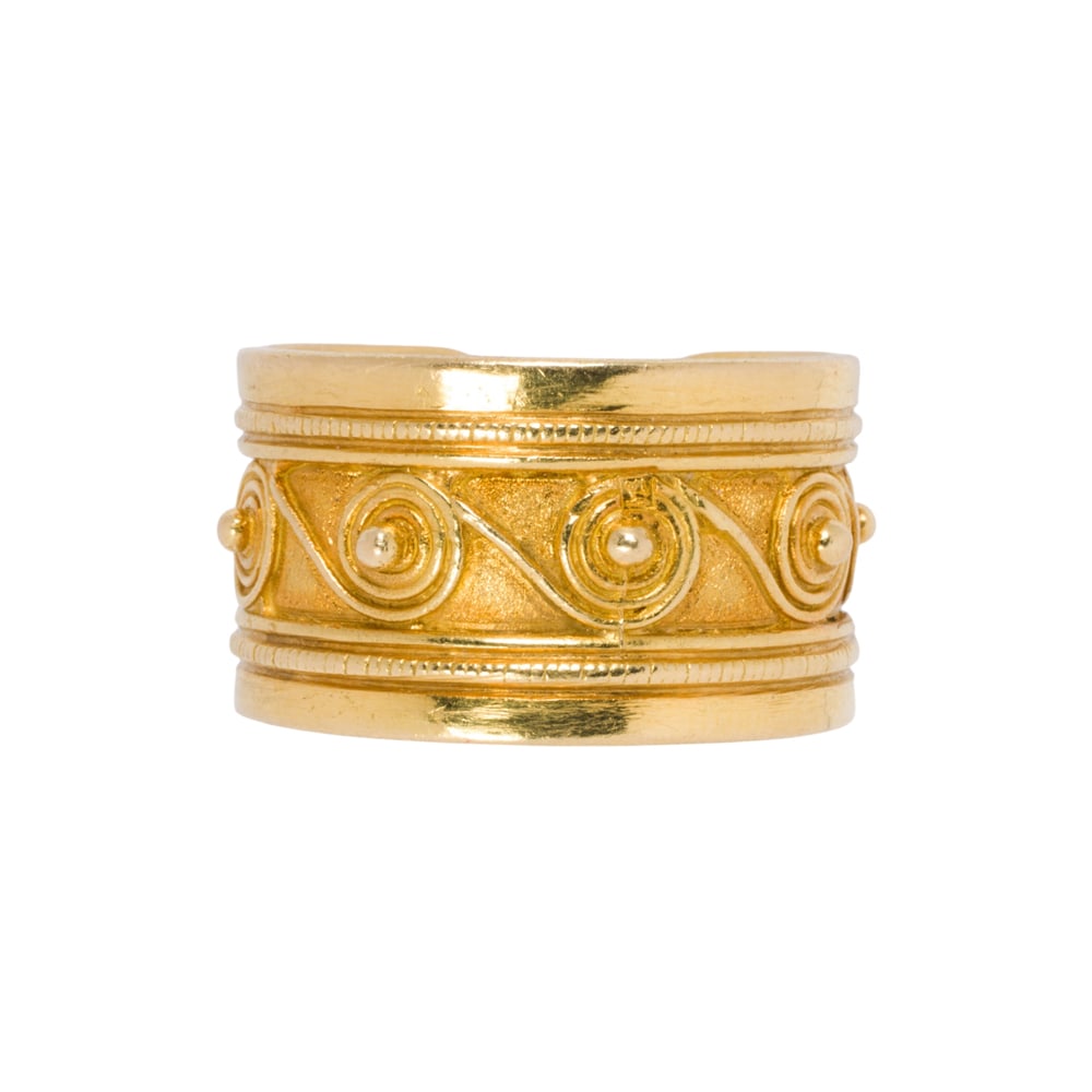 A 20k gold ring: A 20k gold ring Featuring a repeating wave pattern; size 7; 9.45 grams