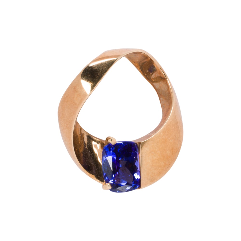 A Suave tanzanite and 14k gold pendant: A Suave tanzanite and 14k gold pendant centering a cushion-cut tanzanite measuring approximately 8.44 x 6.27 x 4.15 mm, length 1 in; 6.70 grams