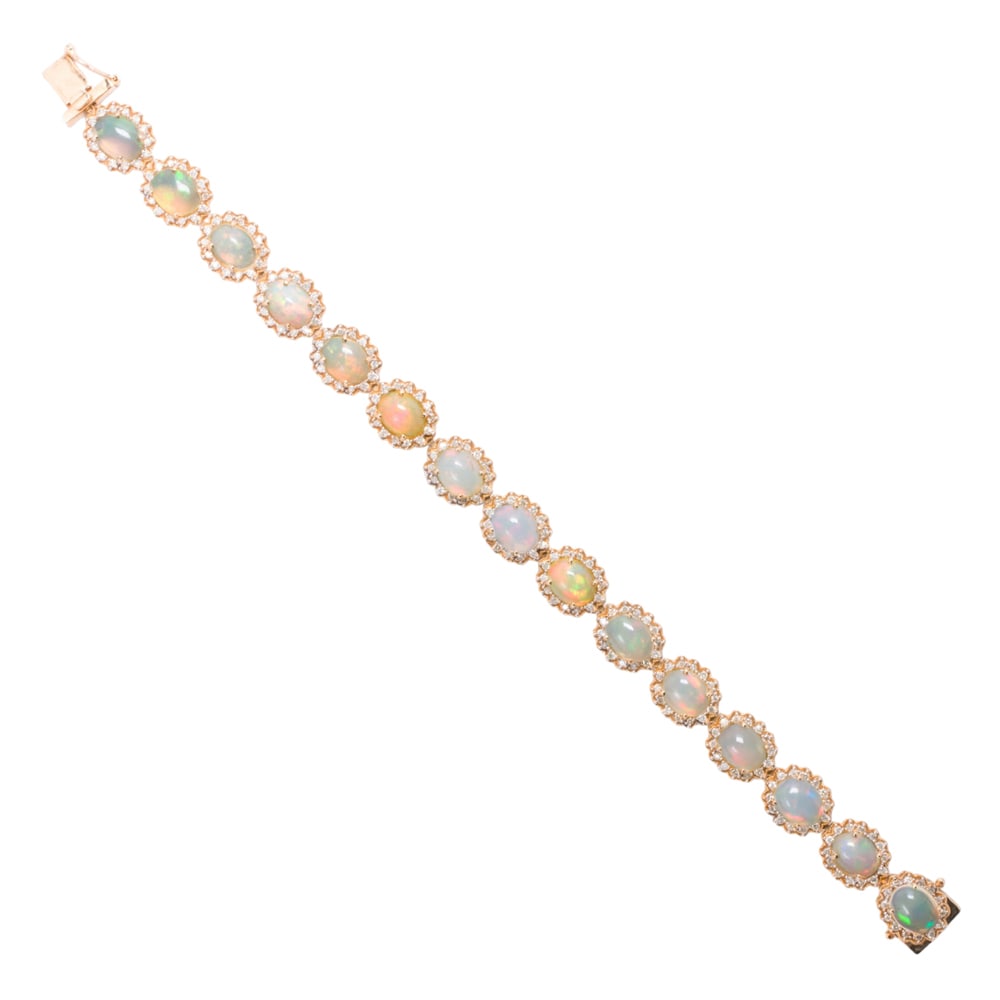 An Orianne opal, diamond, and 14k gold bracelet: An Orianne opal, diamond, and 14k gold bracelet Designed as a line of 15 oval-shaped opal cabochons weighing a total of 15.61 carats, each with round-cut diamond surround; total diamond weight: 2.01 c