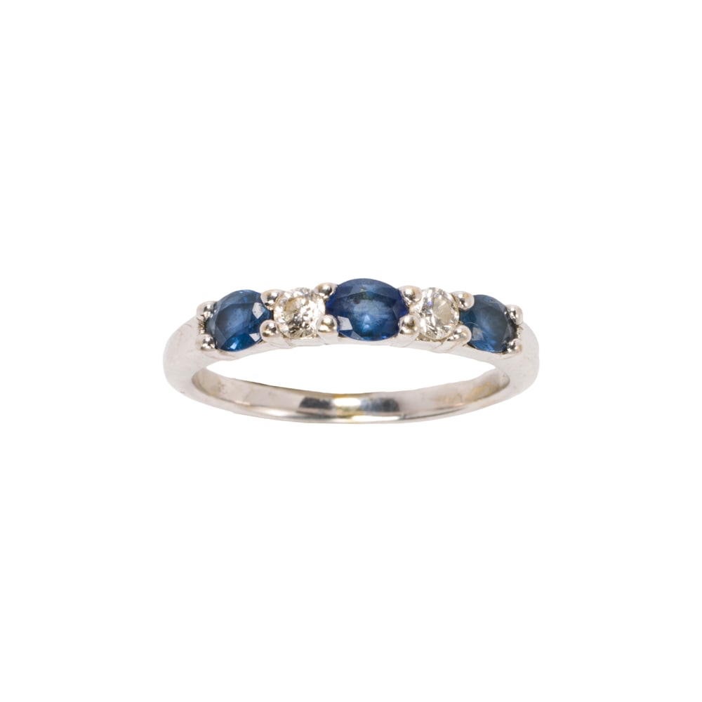 A sapphire, diamond, and 18k white gold ring: A sapphire, diamond, and 18k white gold ring Set with three oval-cut sapphires weighing approximately 0.60 carat, interspersed by two round brilliant-cut diamonds; size 5 1/2; 2.60 grams