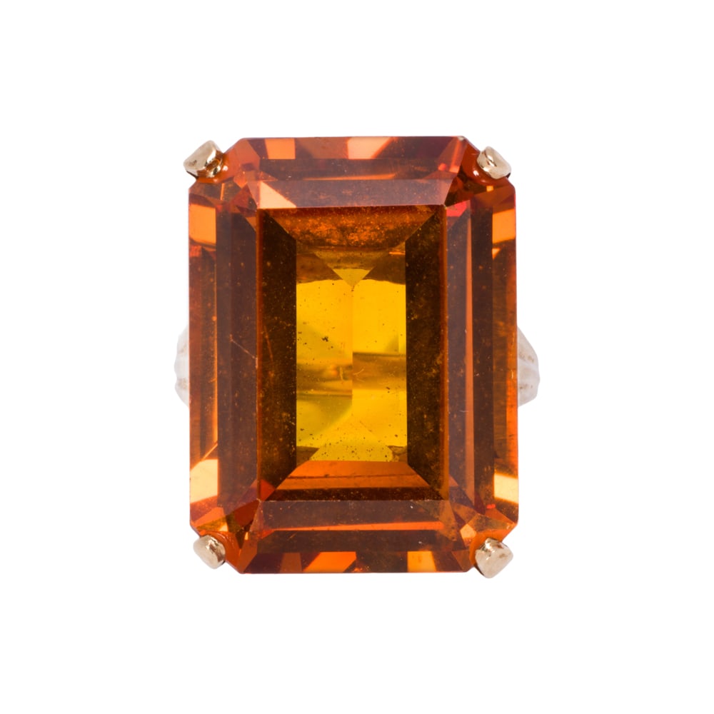 A citrine and 14k gold ring: A citrine and 14k gold ring The ring set with one emerald-cut citrine weighing approximately 20.30 carats; size 5 1/2; 9.15 grams