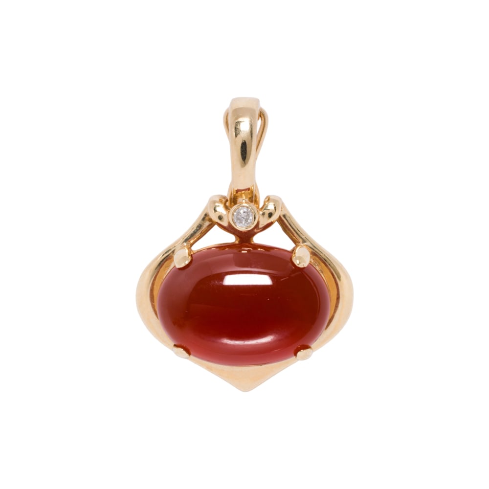 A diamond, carnelian, and 14k gold pendant: A diamond, carnelian, and 14k gold pendant Featuring an oval-shaped carnelian cabochon measuring 14.05 x 9.73 x 5.11 mm, accented by one round-cut diamond; length: 1 in; 3.60 grams
