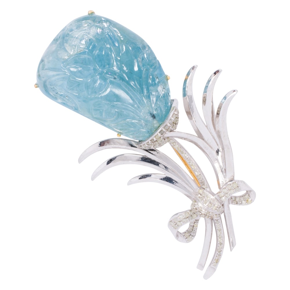An aquamarine, silver, and diamond brooch: An aquamarine, silver, and diamond brooch Featuring a Mughal style aquamarine carving weighing 91.41 carats, accented by round-cut diamonds weighing 0.82 carat total; length: 3 in; 32.40 grams