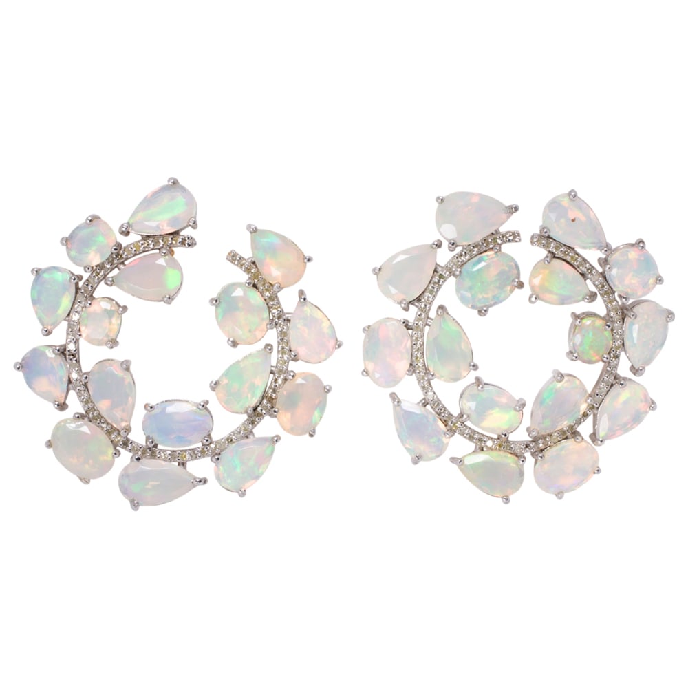 An opal, diamond, silver, and 14k gold pair of earrings: An opal, diamond, silver, and 14k gold pair of earrings The silver earrings featuring an arrangement of pear and oval-cut opals, accented by round-cut diamonds, with 14k gold posts and backings;