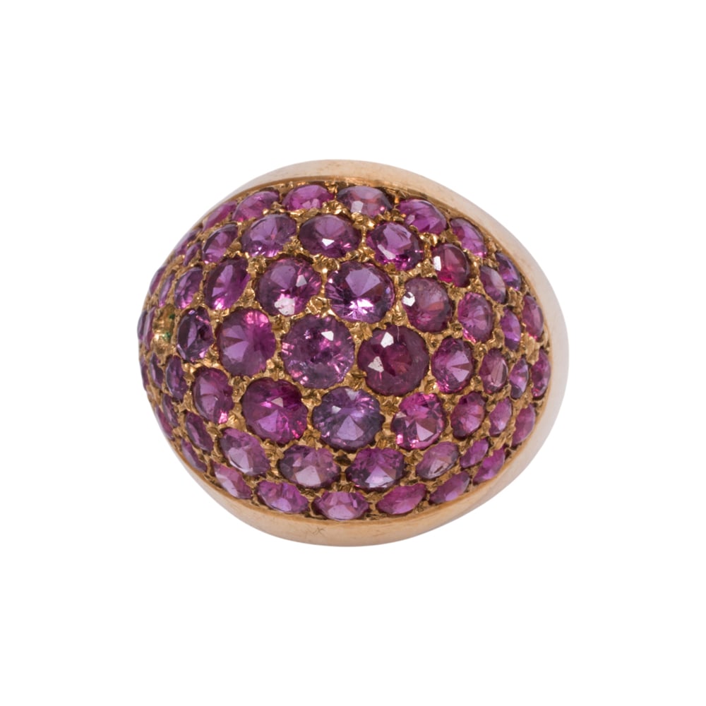 A ruby and 14k gold ring: A ruby and 14k gold ring Of dome design, set with numerous round-cut rubies; size 6 1/2; 8.45 grams Condition note: void one stone