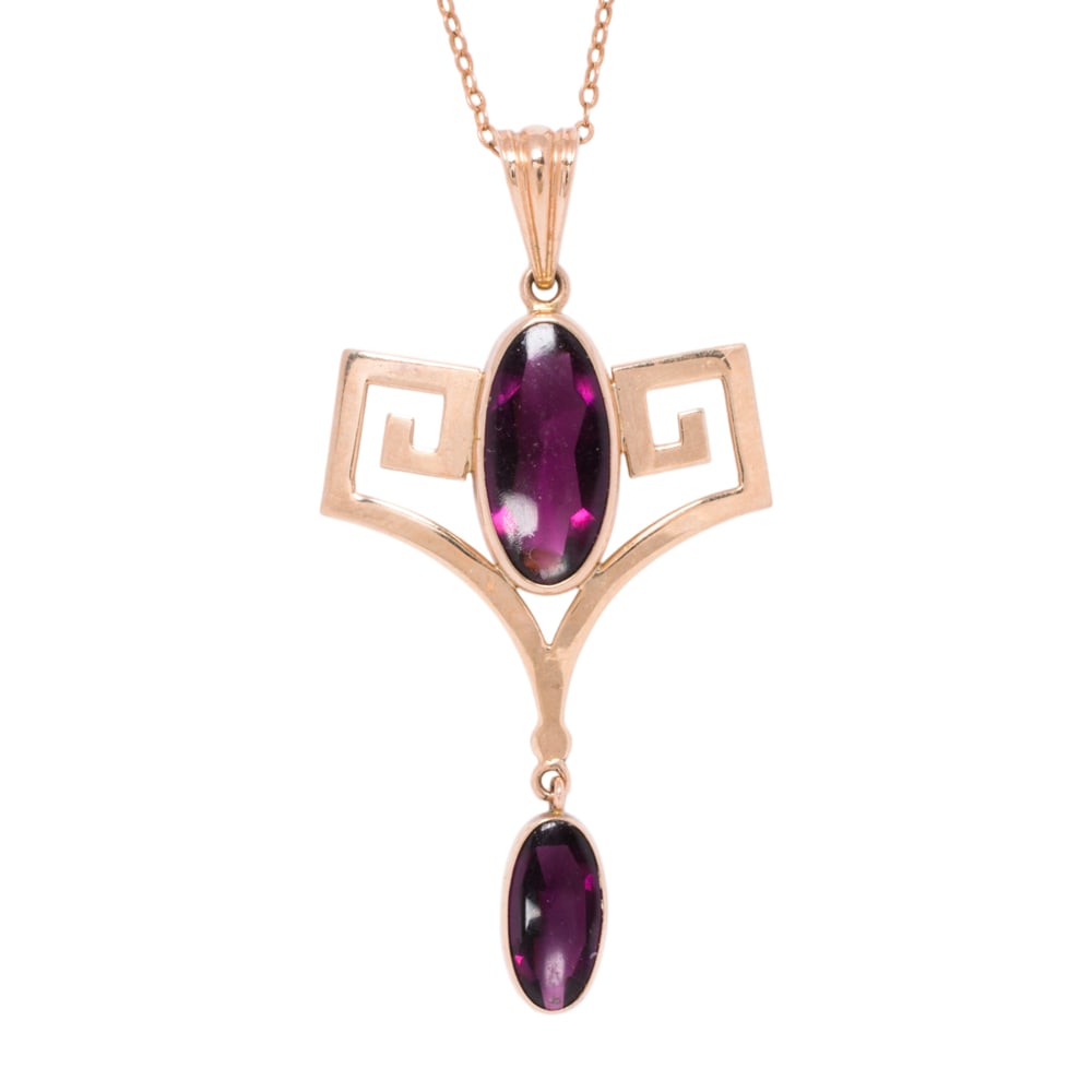 A tourmaline and 10k gold pendant necklace: A tourmaline and 10k gold pendant necklace Of geometric design, set with two oval-shaped tourmaline cabochons measuring 13.29 x 6.50 x 4.13 and 9.70 x 5.02 x 2.89 mm, on cable link chain; pendant