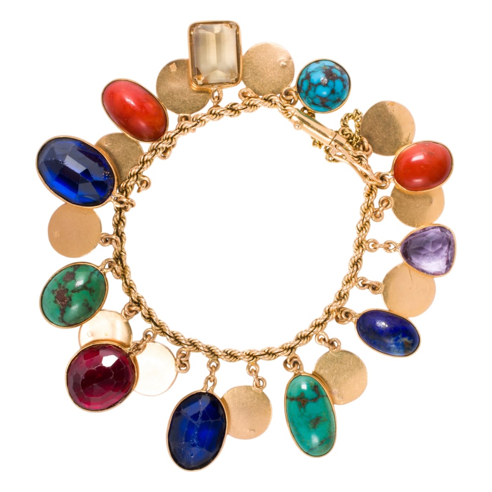 A hardstone and 14k gold bracelet: A hardstone and 14k gold bracelet Designed with a variety of hardstones including coral and turquoise; length: 7 in; 43.85 grams