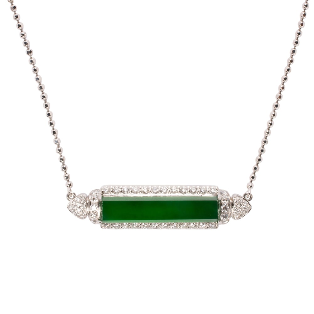 An "A" jade, diamond, and 18k white gold necklace: An "A" jade, diamond, and 18k white gold necklace The necklace featuring a rectangular jade tablet measuring 23.55 x 5.16 mm, set within a frame of round brilliant-cut diamonds weighing a total of