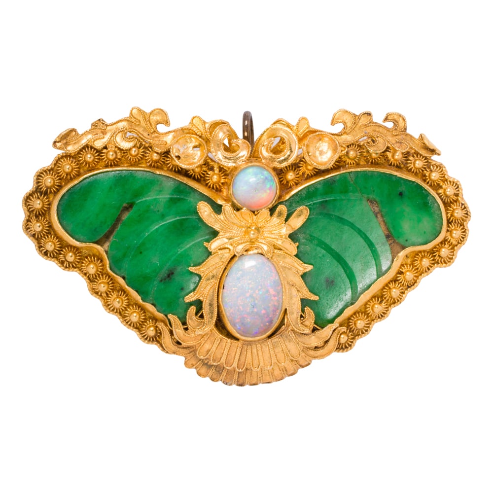 A jade, opal, and high karat gold butterfly brooch-pendant: A jade, opal, and high karat gold butterfly brooch-pendant Designed as a butterfly, featuring an intricate high karat gold frame, accented by an oval and round-shaped opal cabochon measuring 8.90 x