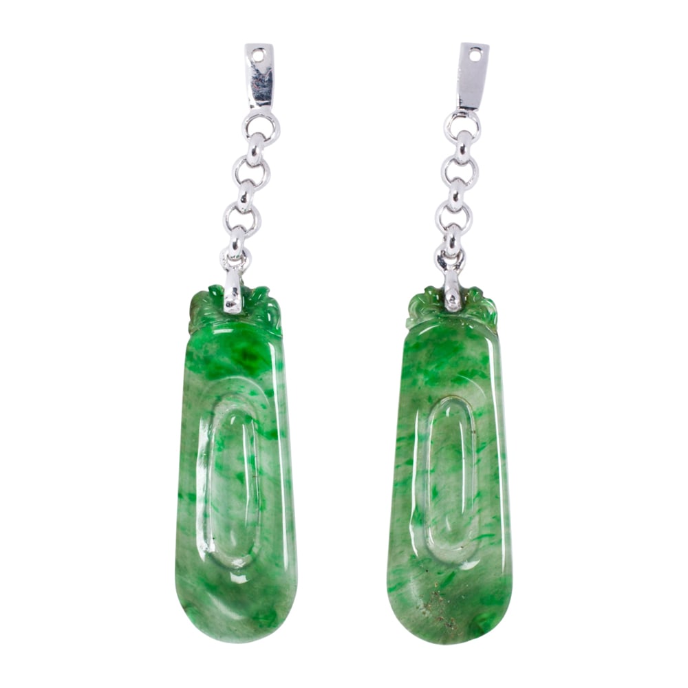 A pair of jade and platinum earring enhancers: A pair of jade and platinum earring enhancers Featuring carved jade tablets on platinum links; length; 1 3/4 in; 2.35 grams