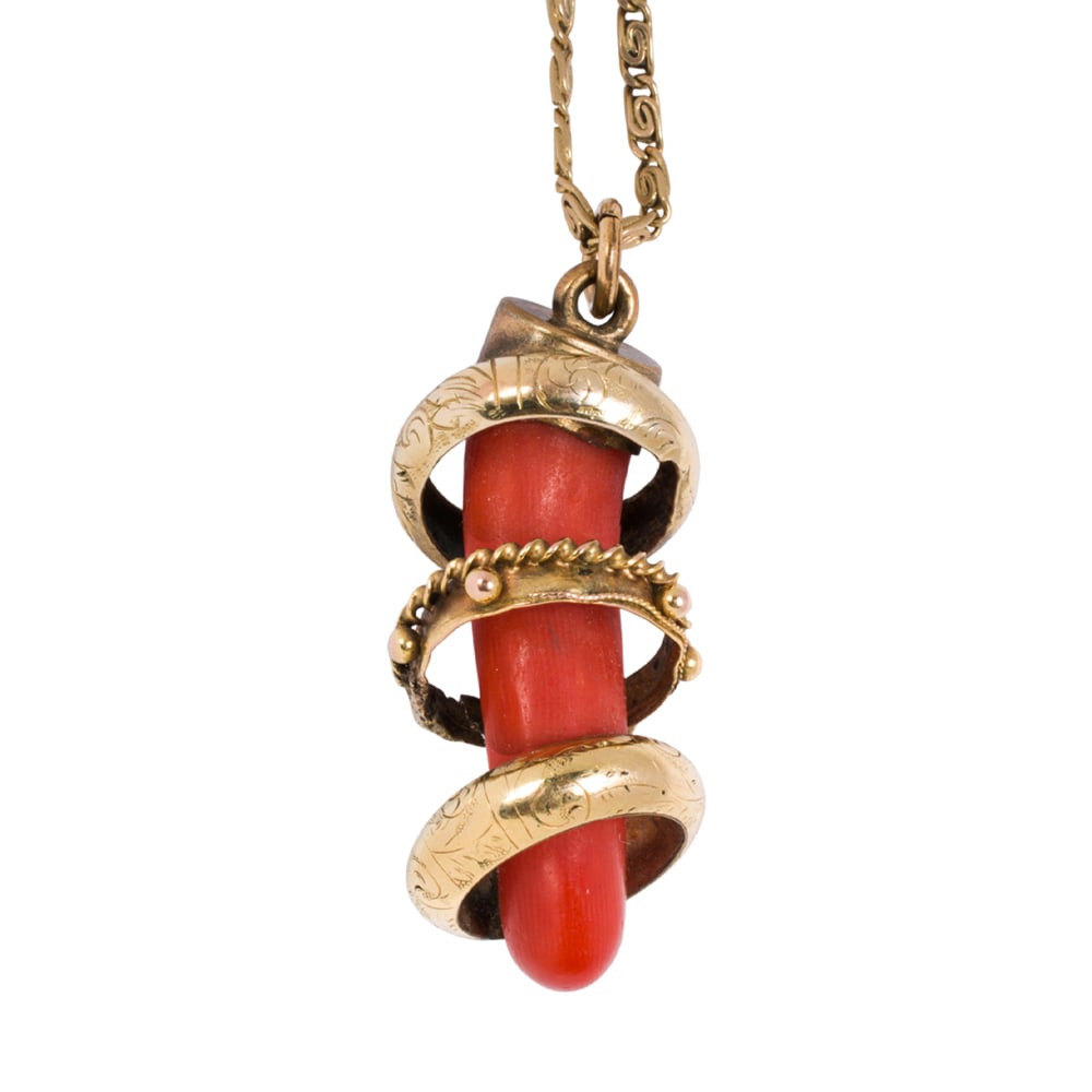 An antique coral, gold, and gold-filled pendant necklace: An antique coral, gold, and gold-filled pendant necklace The coral pendant surrounded by three 18k gold rings, on gold-filled bail and 14k fancy link chain; pendant length: 1 5/8 in; chain length: 20