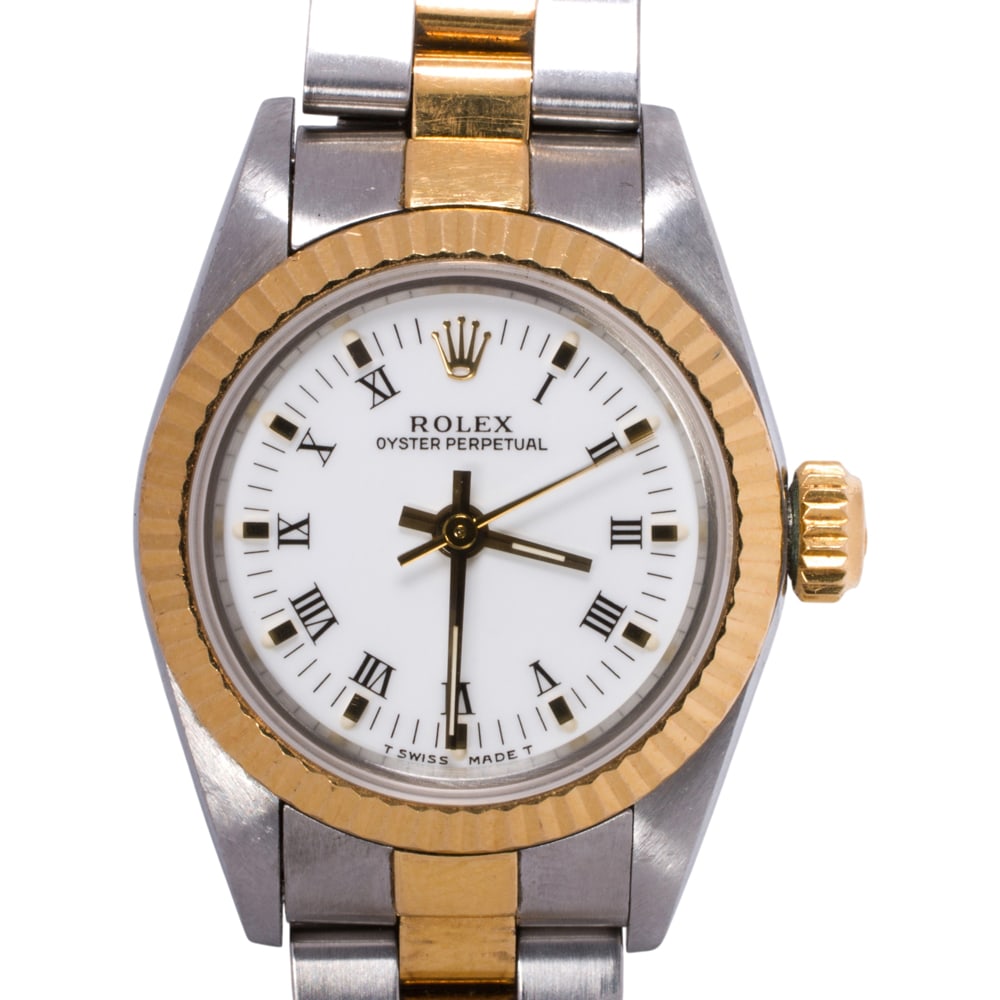 A ladies 1987 Rolex Oyster Perpetual 18k gold and stainless steel wristwatch: A ladies 1987 Rolex Oyster Perpetual 18k gold and stainless steel wristwatch Serial no.: R430220Ref no.: 67193The white dial with 18k gold dot indices with applied roman hours and gold baton hands, wi