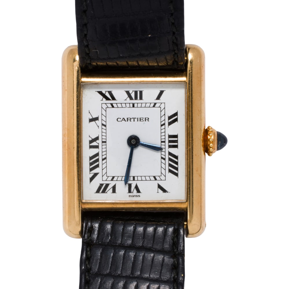 A Cartier 18k gold watch: A Cartier 18k gold watch Case no.: 7808711472The white tone face, black Roman indices, blue sword hands, within polished 18k gold case, set with one sapphire cabochon, containing a manual movement, on