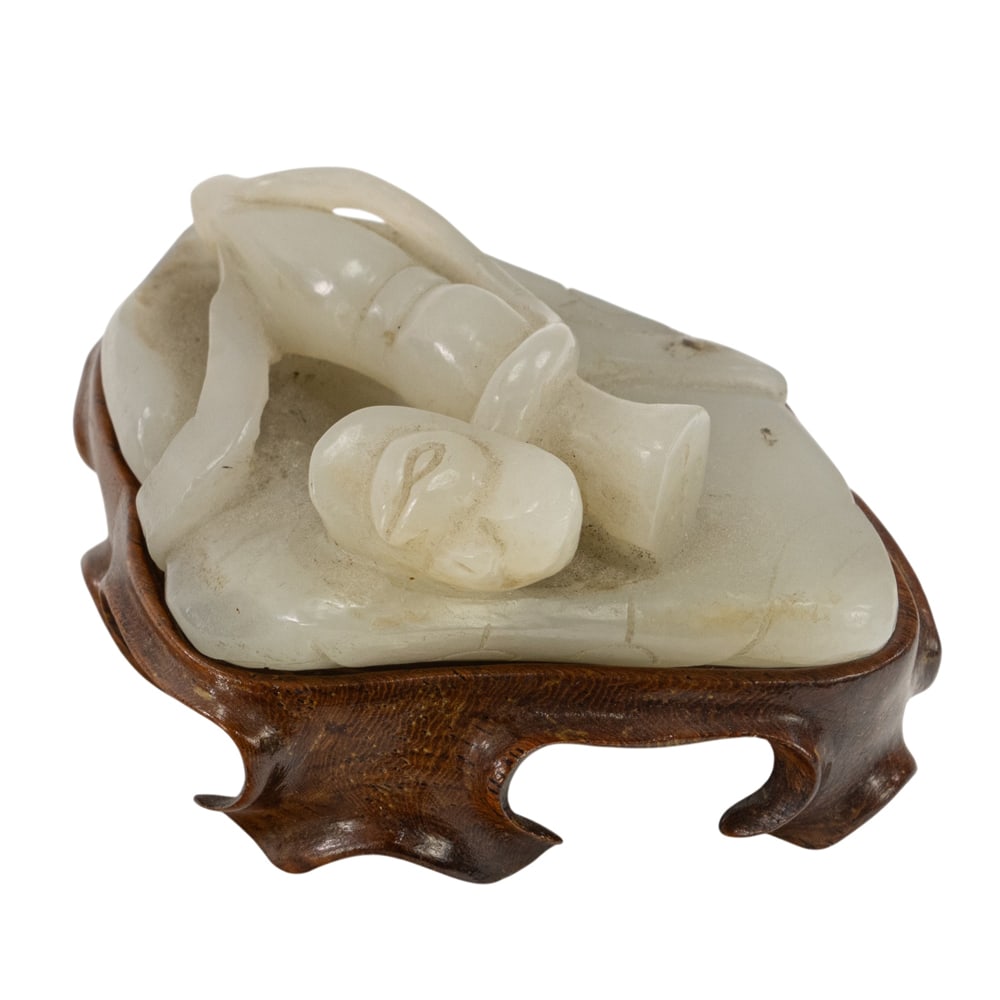 A Chinese celadon jade carving 'lotus' toggle (1 of 3)
