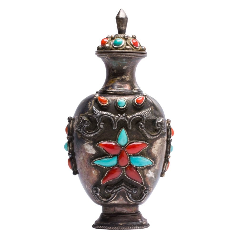 A Mongolian silver, coral, and turquoise snuff bottle: A Mongolian silver, coral, and turquoise snuff bottle. Featuring floral motif, 19th century, 3.625" high.