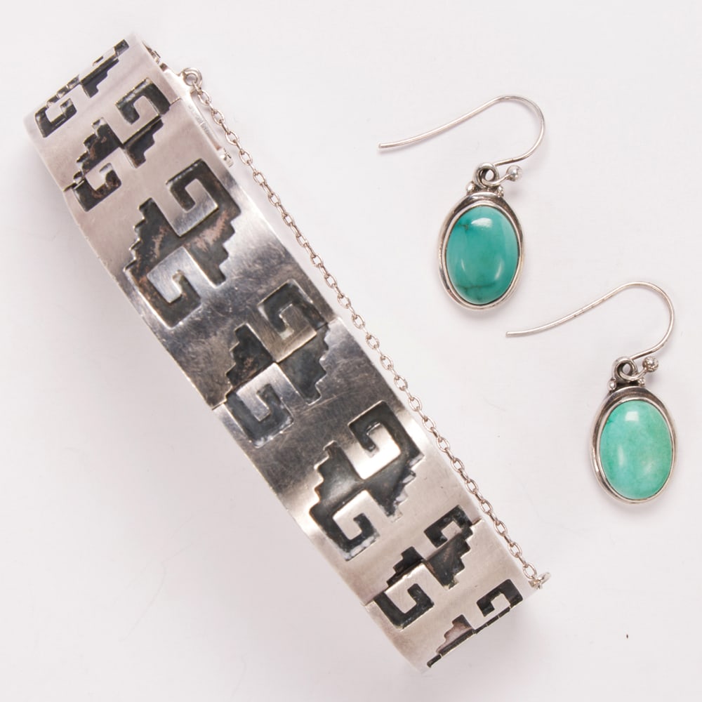 A pair of silver earrings and bracelet: A pair of silver earrings and bracelet comprising a silver link bracelet; marked "RMG" accompanied by a pair of turquoise earrings; 55.80 gross grams; bracelet length: 7 in: earrings length: 1 1/4 in