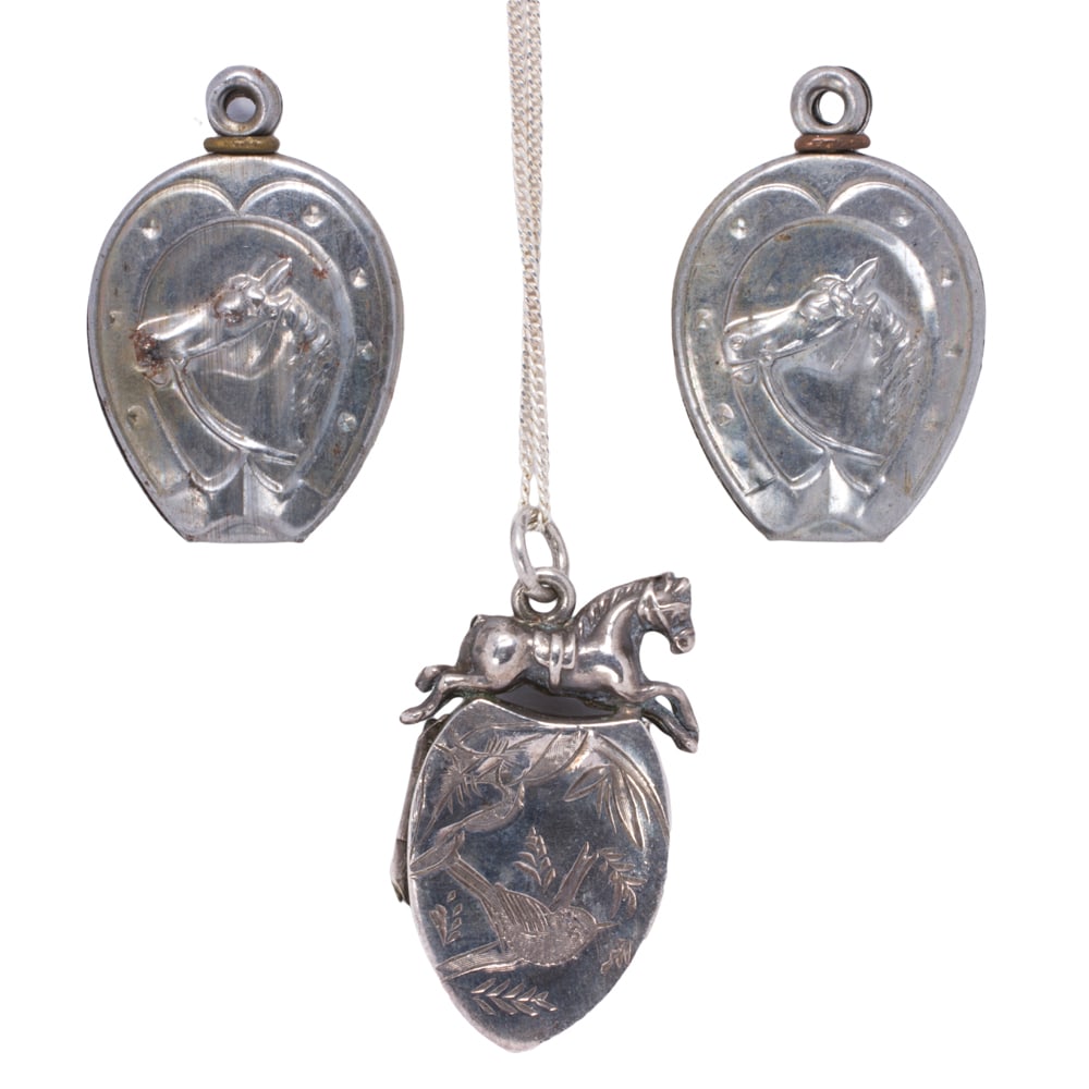 Three equestrian themed charms and locket necklace: Three equestrian themed charms and locket necklace Comprising two charms and one locket necklace featuring equestrian motifs; gross weight: 6.75 grams