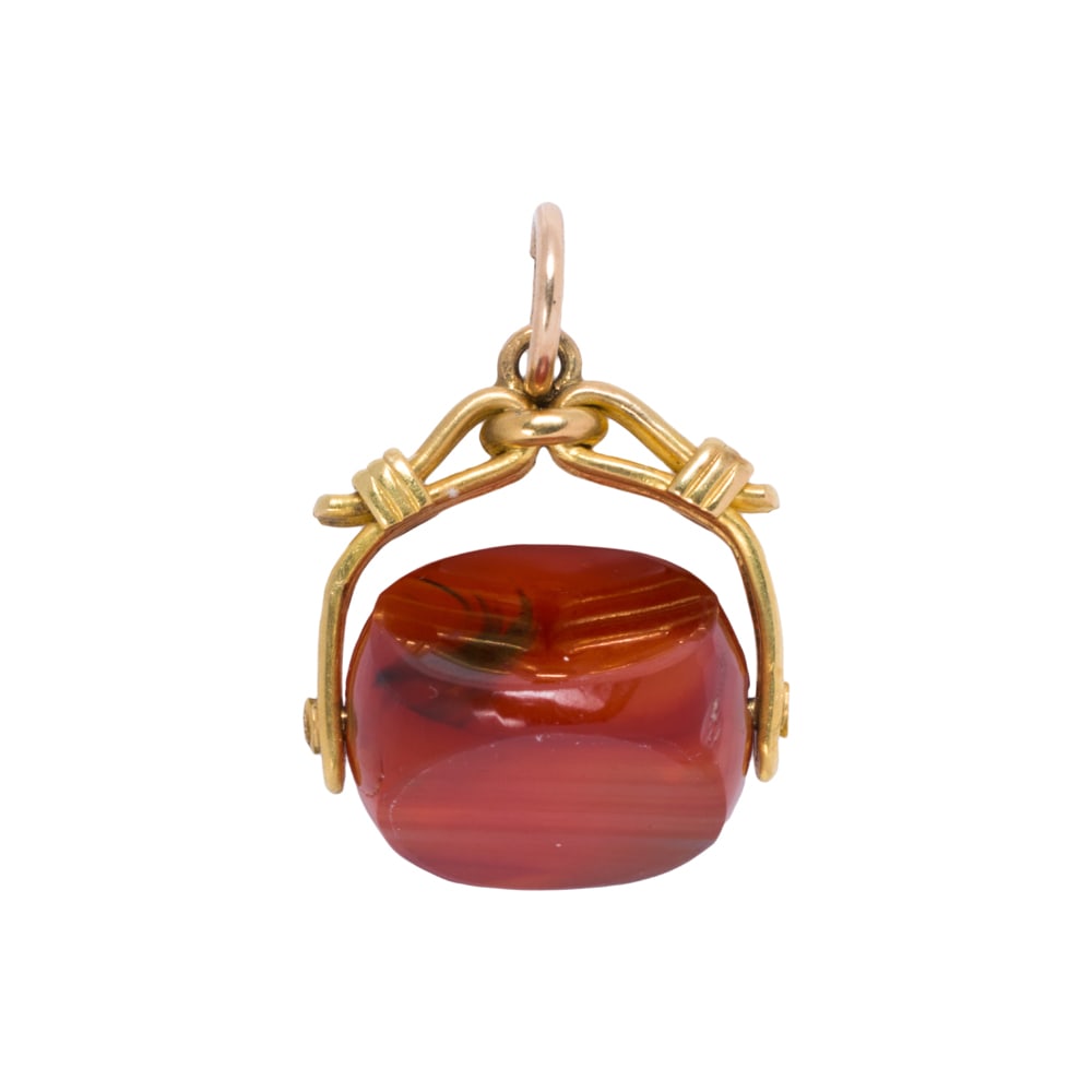 An agate and 18k gold watch fob: An agate and 18k gold watch fob The fob featuring a polished piece of agate set within 18k gold; length: 1 in; 5.10 grams