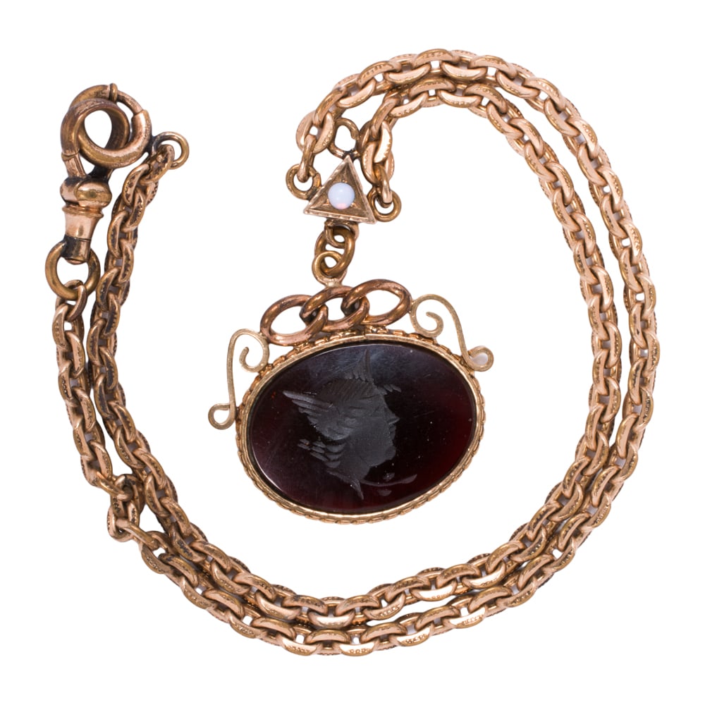 An antique gold-filled chain and fob: An antique gold-filled chain and fob Featuring a triangular spacer set with a round-shaped opal cabochon measuring 3.06 mm, with glass intaglio fob depicting apollo; fob length: 1 3/8 in; chain
