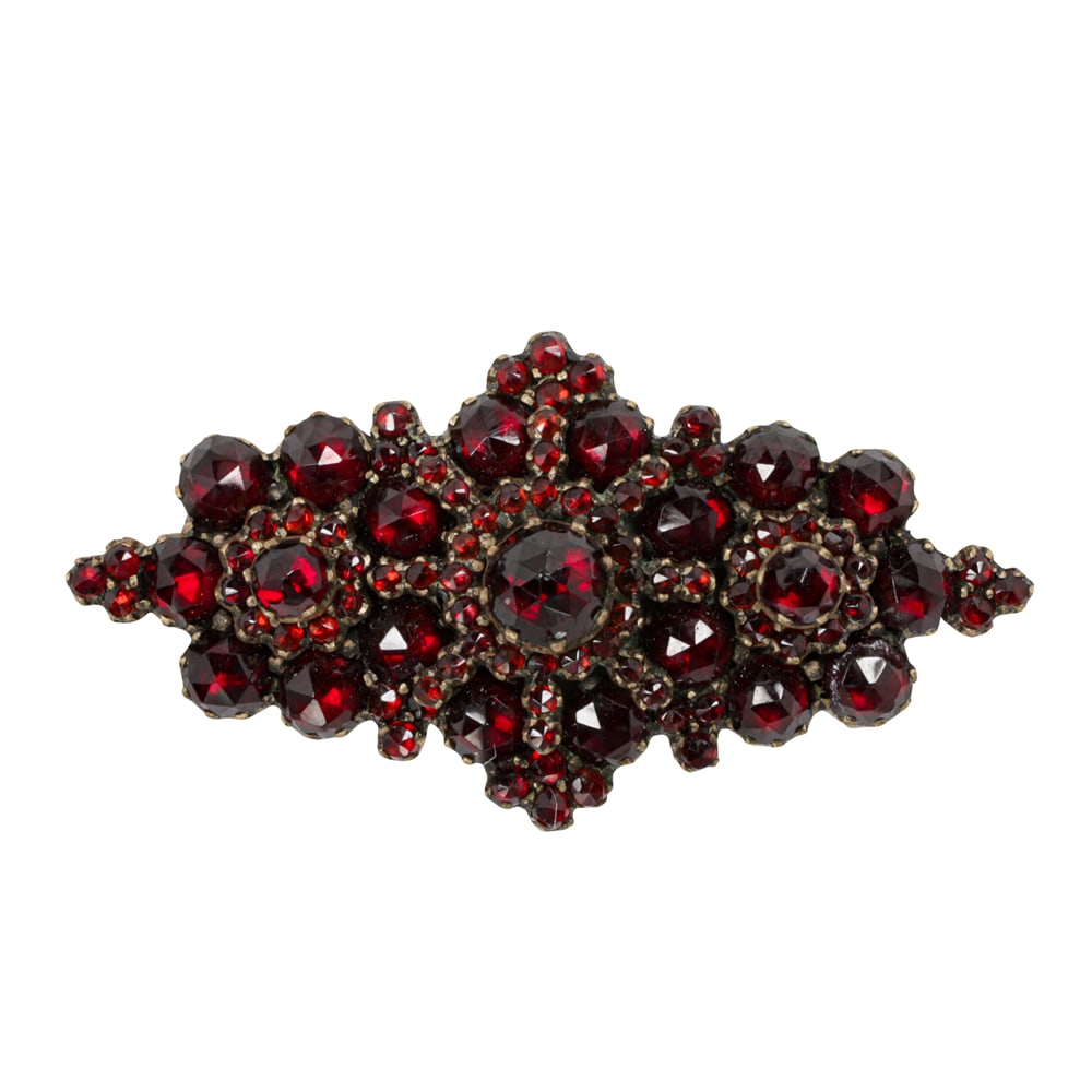 An antique garnet and gold-filled pin: An antique garnet and gold-filled pin Set with numerous rose-cut garnets; length: 1 1/2 in; 5.55 grams
