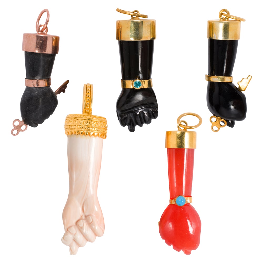 Five hardstone, silver, and gold-filled figa pendants: Five hardstone, silver, and gold-filled figa pendants Comprising two silver and three gold-filled figa pendants made of varying materials including coral; gross weight: 29.75 grams