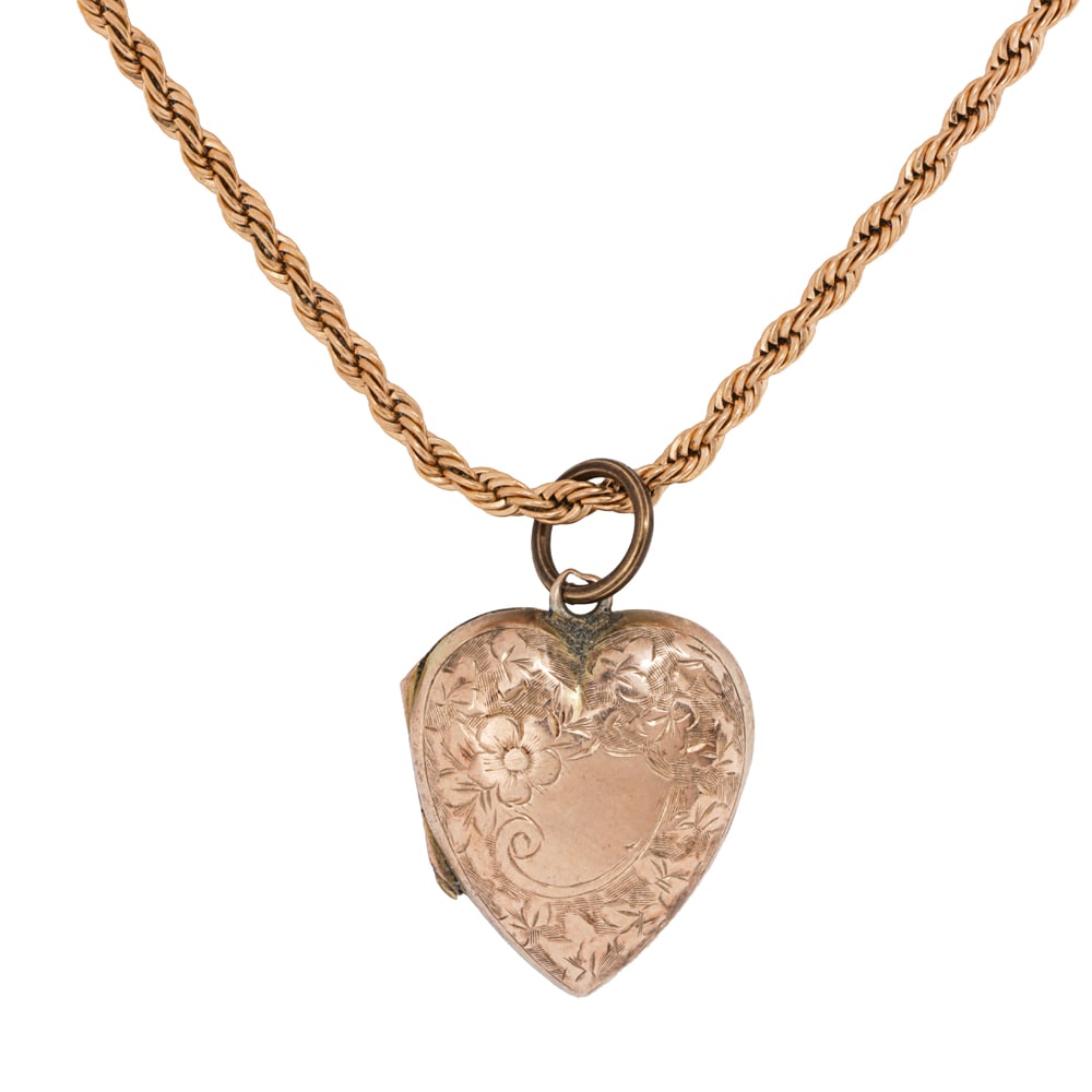 A 9k gold and gold-tone heart locket necklace: A 9k gold and gold-tone heart locket necklace Featuring an antique 9k gold locket on modern gold-tone chain; pendant length: 1 in; chain length: 16 in; 7.40 grams