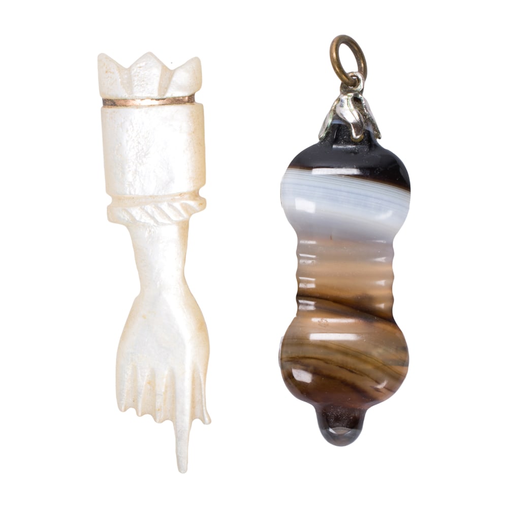 Two figa pendants: Two figa pendants Comprising one agate and one mother of pearl figa pendant; lengths: 2 in; gross weight: 10.75 grams