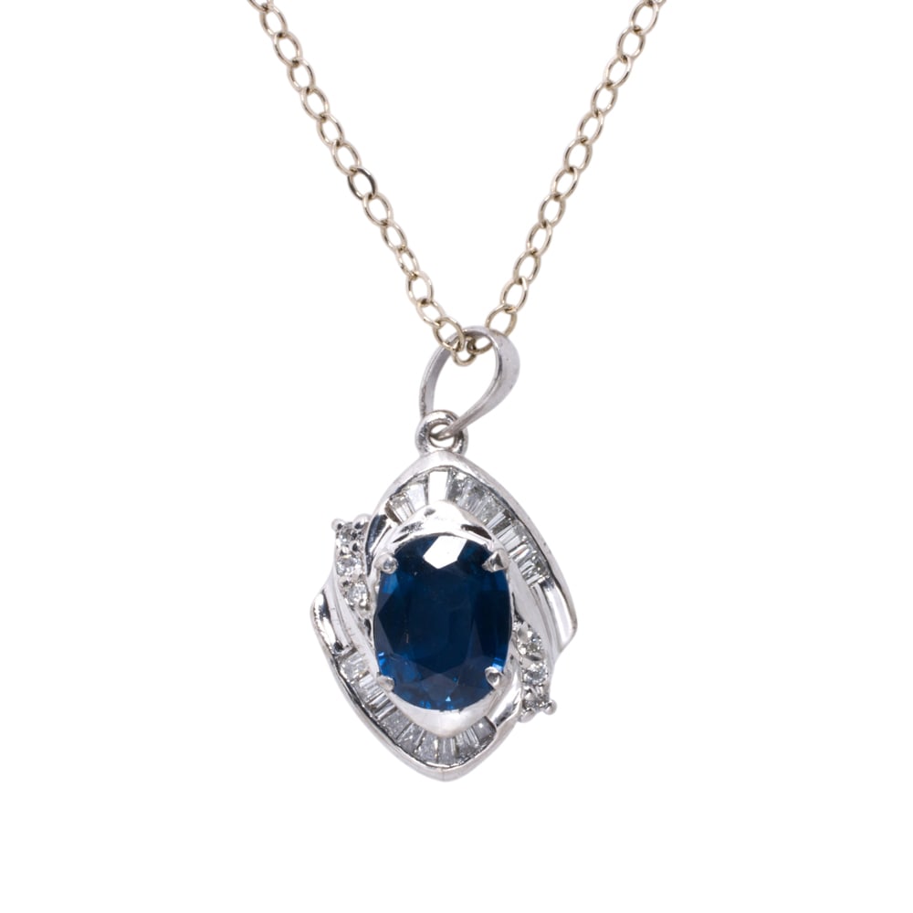 A sapphire, diamond, platinum and 14k white gold pendant necklace: A sapphire, diamond, platinum and 14k white gold pendant necklace centering an oval cut sapphire weighing approximately 1.28 carats, accented by baguette-cut diamonds, on 14k white gold chain; chain l
