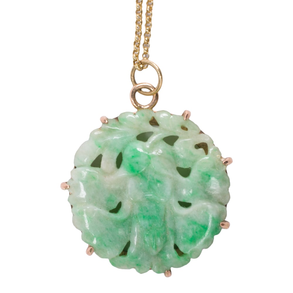 A jade, 10k gold, and gold filled pendant necklace: A jade, 10k gold, and gold filled pendant necklace The pendant featuring a round-shaped carved jade piece in gold-filled setting, on 10k gold chain; pendant length: 1 1/4 in; chain length: 18 in;