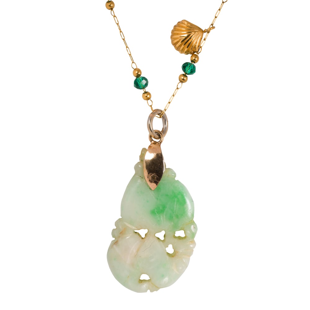A jade pendant: A jade pendant Designed as a carved jade piece; length: 1 1/2 in; 3.75 grams