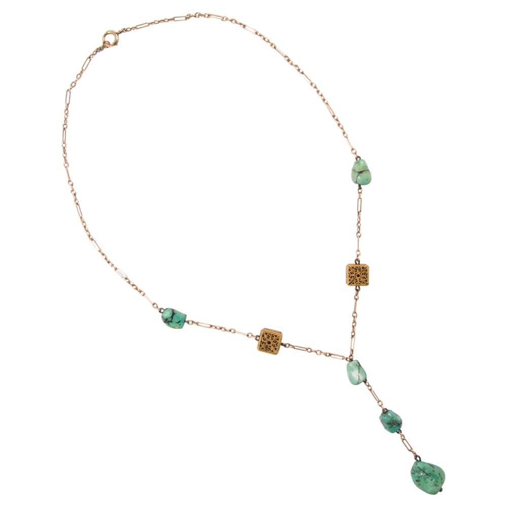 A turquoise and gold tone necklace: A turquoise and gold tone necklace Featuring five polished, freeform turquoise beads interspersed by two cubic filigree spacers; length: 17 in; 8.55 grams