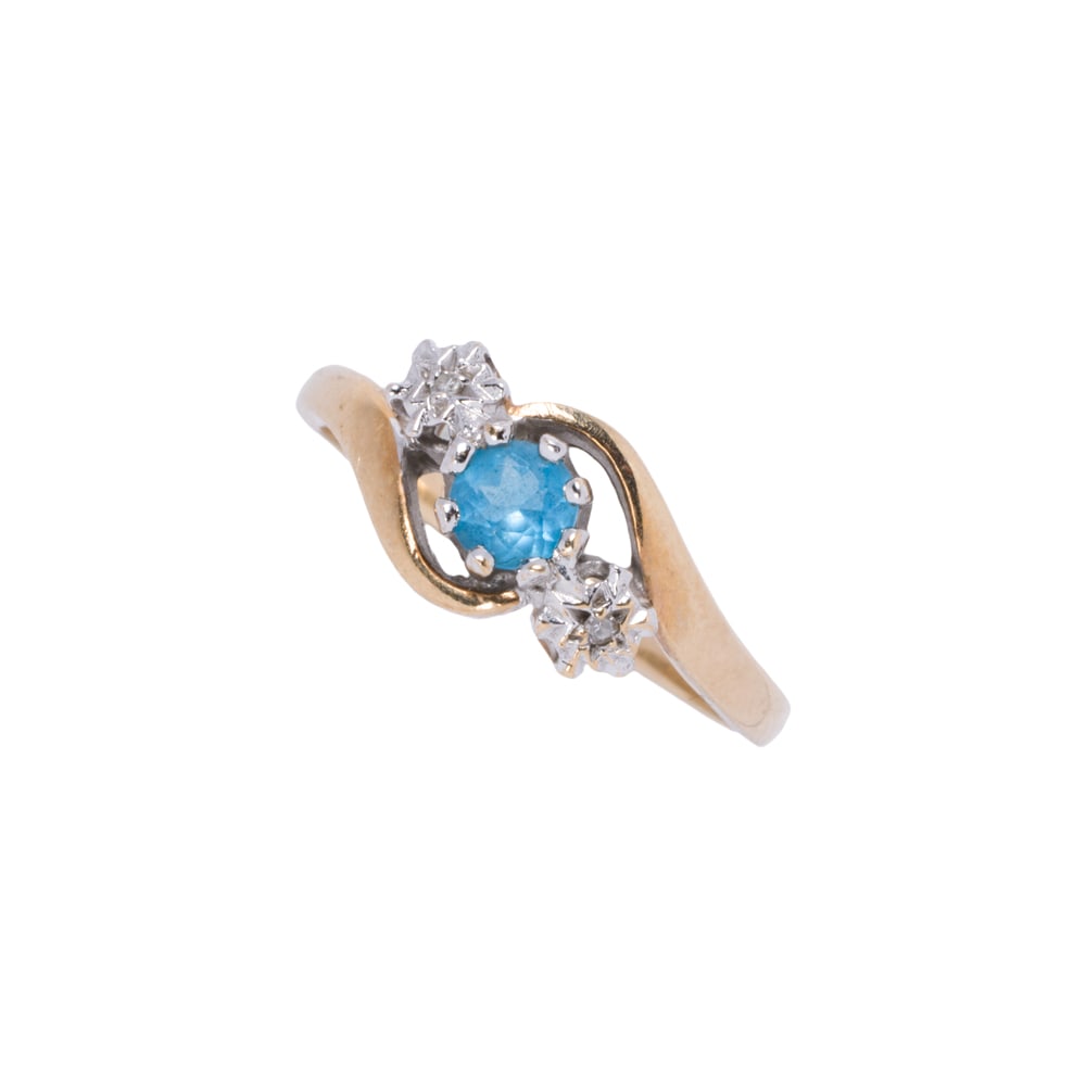 A topaz, diamond, and gold plated ring: A topaz, diamond, and gold plated ring The ring set with a round-cut topaz, framed on either side by one single-cut diamond; size 7; 2.45 grams