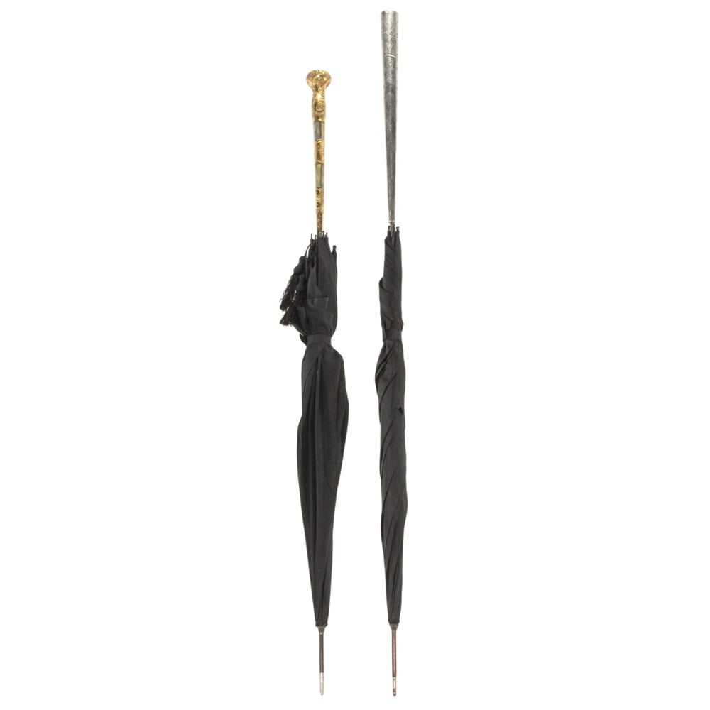Two antique parasols: Two antique parasols, late 19th/early 20th century, comprising one with gold fill and mother-of-pearl handle; the second with silver cased handle, 44.25"l and 40.5"l