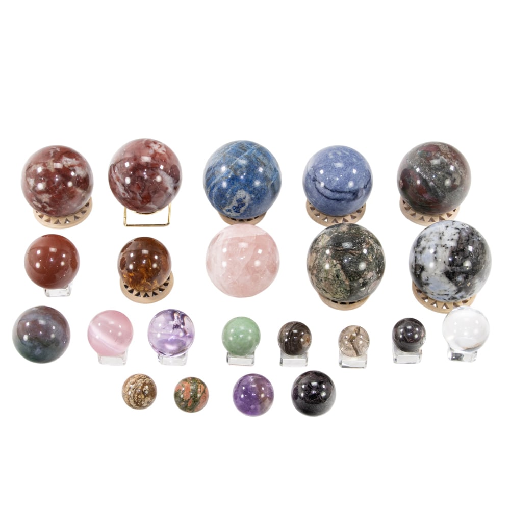 A collection of twenty-two stone spheres: A collection of twenty-two stone spheres, consisting of various stones, sizes, and stands, between 1"dia and 3"dia
