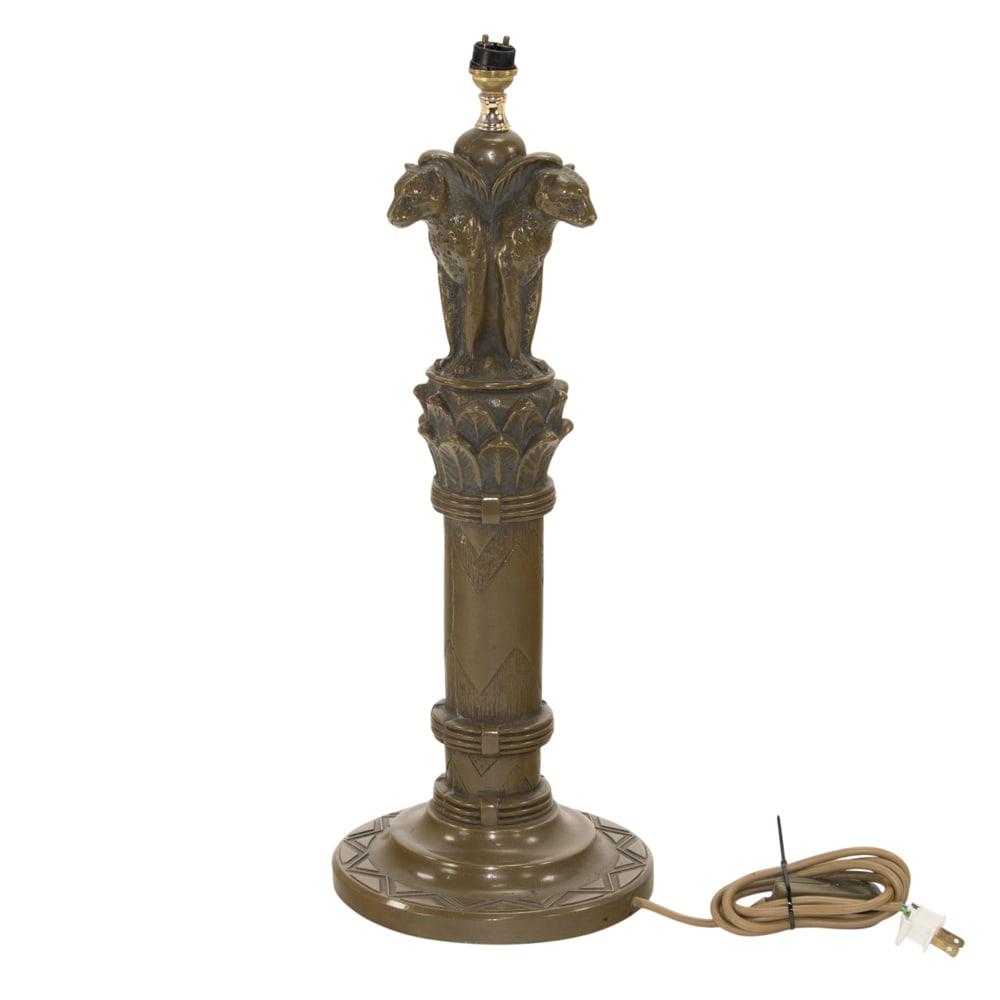 An American Art Deco bronze clad table lamp: An American Art Deco bronze clad table lamp, attributed to Pompeian Bronze Co., circa 1920, modeled as three adorsed seated leopards seated on a column with leaf capital and zig-zag design, 19"h
