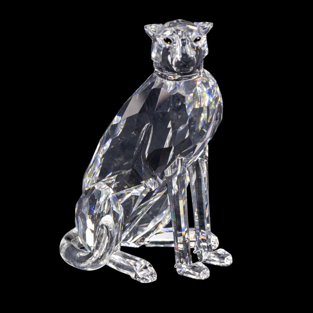 A Swarovski Crystal figure of a seated panther: A Swarovski Crystal figure of a seated panther, acid etched factory mark, 4"h