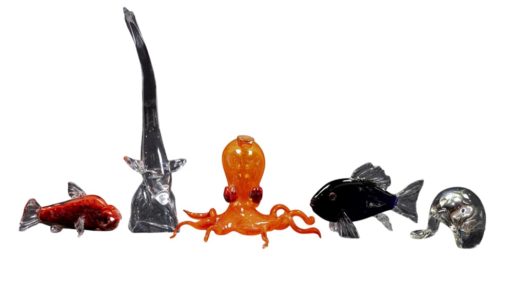 A group of glass sea creatures: A group of glass sea creatures, comprising three colored glass animals with indistinct signatures, including (1) octopus; (1) red dolphin and (1) blue fish; (1) Daum fish on wave, 16.25"h and a (1)