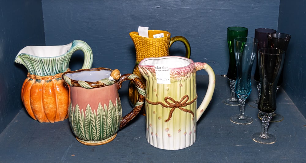 An assembled group of mostly ceramic and glassware: An assembled group of mostly ceramic and glassware, comprising (4) ceramic pitchers, greatest 8.75"h; (5) harlequin set of wine flutes, and (1) contemporary Imari plate and a (1) red striped glass