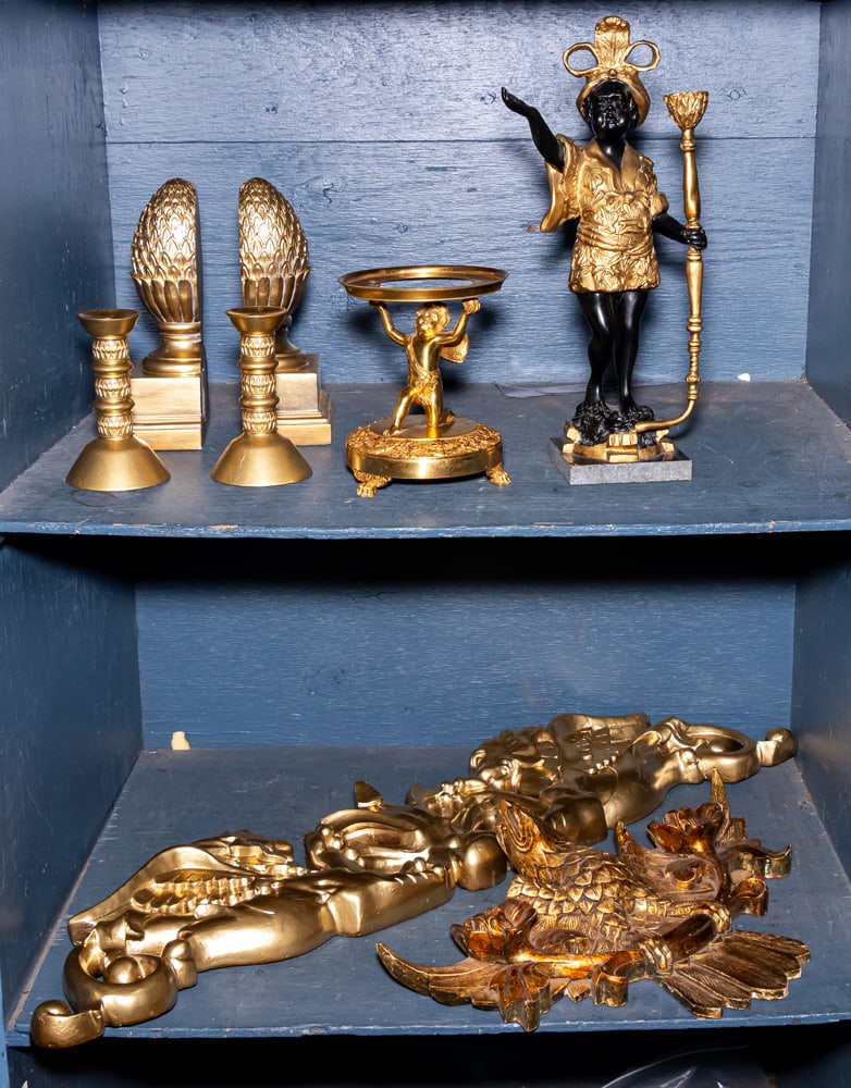 An assembled group of gilt decor: An assembled group of gilt decor, comprising (2) wall appliques; (2) finials form bookends, (2) candlesticks, (1) gilt bronze figural stand, and (1) a composition figural candlestick on marble plinth,