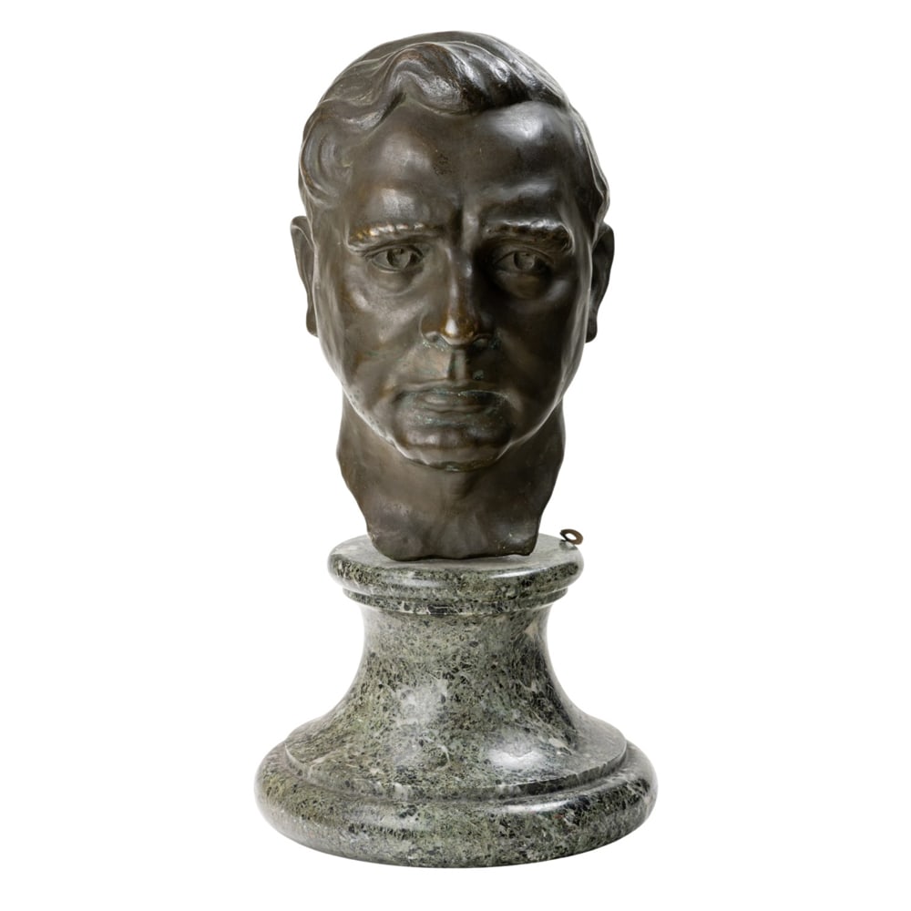 A patinated bronze portrait of a man: A patinated bronze portrait of a man, raised on green marble socle, 17.5"h