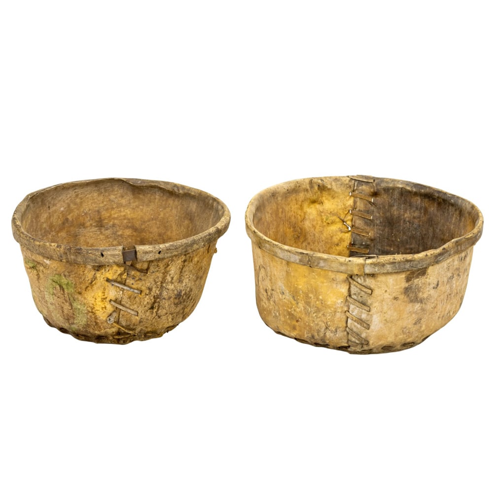 Two large animal hide and wood buckets: Two large animal hide and wood buckets, largest 12"h x 24"dia; smallest 12"h x 22"dia