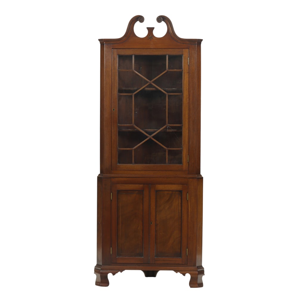 A Federal style corner cabinet in two parts: A Federal style corner cabinet in two parts, with mullion glass door opening to fixed shelves, and rising on bracket feet, 79"h x 31"w x 15.5"d
